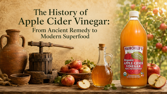 Fairchild’s Organic Apple Cider Vinegar beside apples, an antique press and ancient pottery illustrating the history of apple cider vinegar.