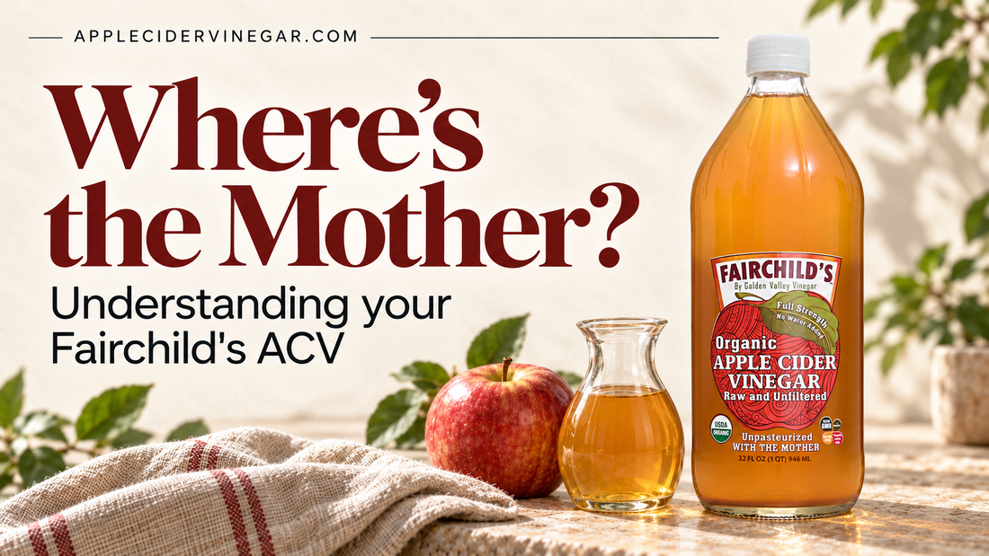 Where’s the Mother? Understanding your Fairchild’s ACV. Wide editorial cover with a Fairchild’s bottle, red apple and small carafe of amber vinegar on a linen-covered counter. Illustrative product scene.