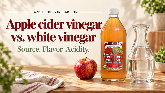 Apple cider vinegar vs. white vinegar: source, flavor and acidity. Fairchild’s amber ACV bottle and an apple beside a clear carafe representing white distilled vinegar on a kitchen counter.